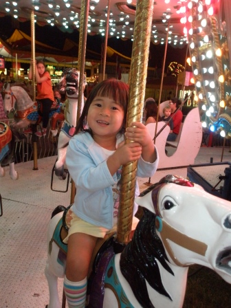 Karis riding the carousel